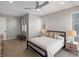 Comfortable main bedroom featuring a ceiling fan, bedside tables, and a large window at 5004 S Platte River Pkwy, Littleton, CO 80123