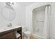 Bathroom featuring modern wood vanity, walk in shower, and modern hardware at 12655 E Pacific Cir # C, Aurora, CO 80014