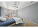 Comfortable bedroom with bay window, bench seat, and ceiling fan for a relaxing retreat at 12655 E Pacific Cir # C, Aurora, CO 80014