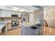 Bright kitchen with modern appliances, a breakfast bar, and adjacent dining area at 12655 E Pacific Cir # C, Aurora, CO 80014