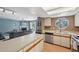 View from kitchen to living area with fireplace and access to outdoor space at 12655 E Pacific Cir # C, Aurora, CO 80014