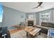 Comfortable living room with modern ceiling fan and decorative brick fireplace at 12655 E Pacific Cir # C, Aurora, CO 80014