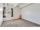 Empty bedroom with a window, neutral carpet, and bright overhead lighting at 384 S Ironton St # 208, Aurora, CO 80012