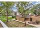 Building exterior with a grassy courtyard, pathway, and trees at 384 S Ironton St # 208, Aurora, CO 80012