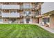 Apartment exterior featuring multiple balconies, lawn area, and walkways at 384 S Ironton St # 208, Aurora, CO 80012