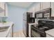 Small kitchen with white cabinets and stainless steel appliances at 384 S Ironton St # 208, Aurora, CO 80012