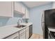 Kitchen with white cabinets, stainless steel appliances, and a sink at 384 S Ironton St # 208, Aurora, CO 80012