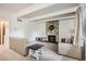 Cozy living room with stone fireplace, neutral furniture, and bright overhead lighting at 384 S Ironton St # 208, Aurora, CO 80012