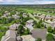 Aerial view of a home in a well-maintained neighborhood near a golf course and mature trees at 7119 S Riviera St, Aurora, CO 80016