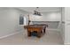 Basement game room features a pool table, carpet flooring, and a window for natural light at 7119 S Riviera St, Aurora, CO 80016