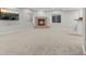 Finished basement featuring a cozy fireplace, neutral carpet, and ample natural light at 7119 S Riviera St, Aurora, CO 80016