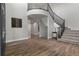 Spacious foyer featuring hardwood floors and staircase with iron railing at 7119 S Riviera St, Aurora, CO 80016