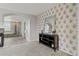 Hallway with decorative wallpaper leads to a bathroom featuring a soaking tub and a shower at 7119 S Riviera St, Aurora, CO 80016