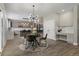 Open-concept kitchen with stainless steel appliances, bar, and dining nook with backyard view at 7119 S Riviera St, Aurora, CO 80016