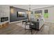 Modern living room boasts a fireplace, sleek decor, a wall-mounted TV, large windows and recessed lighting at 7119 S Riviera St, Aurora, CO 80016