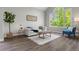 Bright living room with large windows and neutral decor at 7119 S Riviera St, Aurora, CO 80016