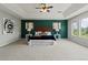 Spacious bedroom with tray ceilings, a decorative accent wall, and an abundance of natural light at 7119 S Riviera St, Aurora, CO 80016