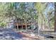 Charming two-story cabin-style home nestled among the trees with a spacious deck and inviting curb appeal at 1065 Independence Dr, Larkspur, CO 80118
