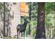 Exterior view of the home in a natural setting with a deer in the yard at 1065 Independence Dr, Larkspur, CO 80118