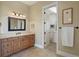 Bright bathroom features a double vanity and access to a hallway at 16394 W 77Th Ln, Arvada, CO 80007