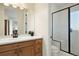 Clean bathroom with a walk-in shower and updated vanity at 16394 W 77Th Ln, Arvada, CO 80007