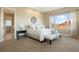 Spacious bedroom with ensuite bathroom access and large window at 16394 W 77Th Ln, Arvada, CO 80007