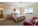 Charming bedroom with a wooden bed frame and window seat at 16394 W 77Th Ln, Arvada, CO 80007