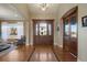 Grand entryway with hardwood floors, arched doorways, and large windows at 16394 W 77Th Ln, Arvada, CO 80007