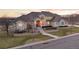 Stunning stucco home boasts a beautifully landscaped front yard and inviting arched entryway at 16394 W 77Th Ln, Arvada, CO 80007