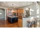 Large kitchen with island, custom cabinetry, and stainless steel appliances at 16394 W 77Th Ln, Arvada, CO 80007