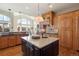 Island kitchen with breakfast bar and high-end finishes at 16394 W 77Th Ln, Arvada, CO 80007