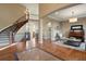 Elegant two-story living room with hardwood floors, curved staircase, and high ceilings at 16394 W 77Th Ln, Arvada, CO 80007