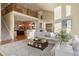 Two story living room with open floor plan and kitchen view at 16394 W 77Th Ln, Arvada, CO 80007