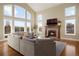 Living room with fireplace, hardwood floors, and abundant natural light at 16394 W 77Th Ln, Arvada, CO 80007