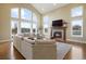 Living room with fireplace, hardwood floors, and abundant natural light at 16394 W 77Th Ln, Arvada, CO 80007
