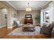 Cozy sitting area with hardwood floors, comfortable seating, and large windows at 16394 W 77Th Ln, Arvada, CO 80007