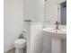Clean half bathroom with a pedestal sink and modern fixtures at 6506 Silver Mesa Dr # F, Highlands Ranch, CO 80130
