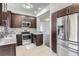 Stylish kitchen with stainless steel appliances, mosaic backsplash, and granite countertops at 6506 Silver Mesa Dr # F, Highlands Ranch, CO 80130