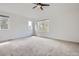 Spacious primary bedroom with large windows and a ceiling fan at 6506 Silver Mesa Dr # F, Highlands Ranch, CO 80130
