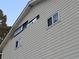 Light beige vinyl siding with two windows and some roof damage at 9464 Newton St, Westminster, CO 80031