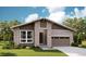 Charming single-story home with a modern design, featuring a brick facade and an attached garage at 1371 Lumber Ridge N Cir, Erie, CO 80516