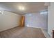 Unfinished basement with carpet, windows, blue accent wall and space for customization at 6131 Wolff St, Arvada, CO 80003