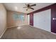 Bedroom features plush carpeting, a ceiling fan, and a large closet at 6131 Wolff St, Arvada, CO 80003