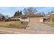 Cozy single-story home with a front lawn, featuring a blend of brick and siding with an attached garage at 6131 Wolff St, Arvada, CO 80003