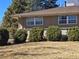 Exterior shot of the home showcasing well-maintained green shrubbery, light brick accents, and energy-efficient windows at 6131 Wolff St, Arvada, CO 80003