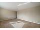 Empty living room featuring neutral-toned walls, plush carpeting, and ample natural light, ready for personalization at 6131 Wolff St, Arvada, CO 80003