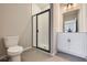 Modern bathroom with a shower, toilet and white vanity at 9656 Browns Peak Cir, Littleton, CO 80125