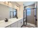 Double vanity bathroom with large mirror and walk-in shower at 9656 Browns Peak Cir, Littleton, CO 80125