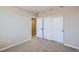 Bedroom with carpet, double doors to closet, and access to upper floor at 9656 Browns Peak Cir, Littleton, CO 80125