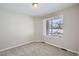 Well-lit bedroom featuring carpeted floors and a window at 9656 Browns Peak Cir, Littleton, CO 80125